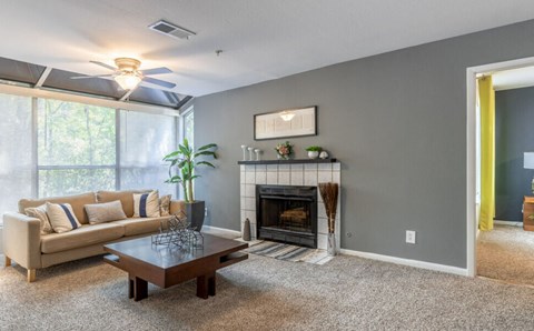 a living room with a couch and a coffee table and a fireplace